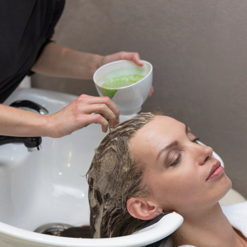 woman applying green tea for hair