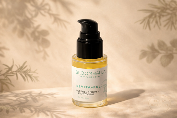 Revita+Fol adaptogenic botanical scalp serum bottle with rosemary and holy basil shadows on a neutral background.