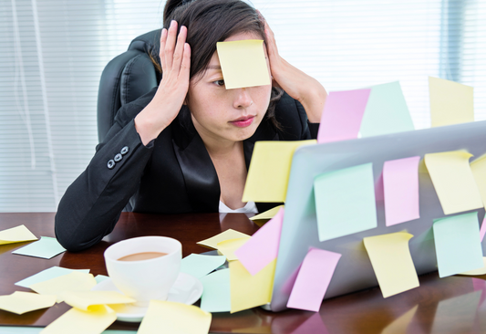 stressed woman at messy office desk